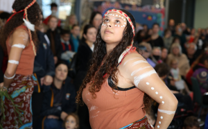 First Nations woman dressed in traditional Aboriginal clothing and performing a traditional dance.