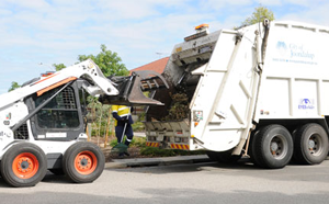 Waste truck picking up vergeside waste. 