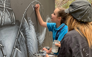 People painting a mural