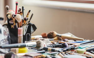 Pile of make-up on table