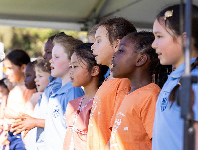 Children choir singing on stage