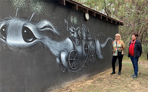 Group of people viewing a mural 