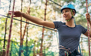 Young person on tree top walkway