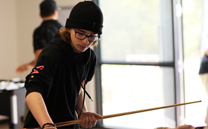 A boy playing pool